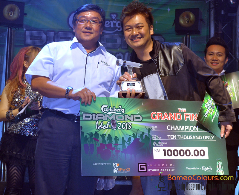 Mr Teoh Nar Teik (left), Regional Sales Manager of Carlsberg Malaysia, presenting the mock cheque to Sylvester Lee, Carlsberg Diamond Idol 2013 champion